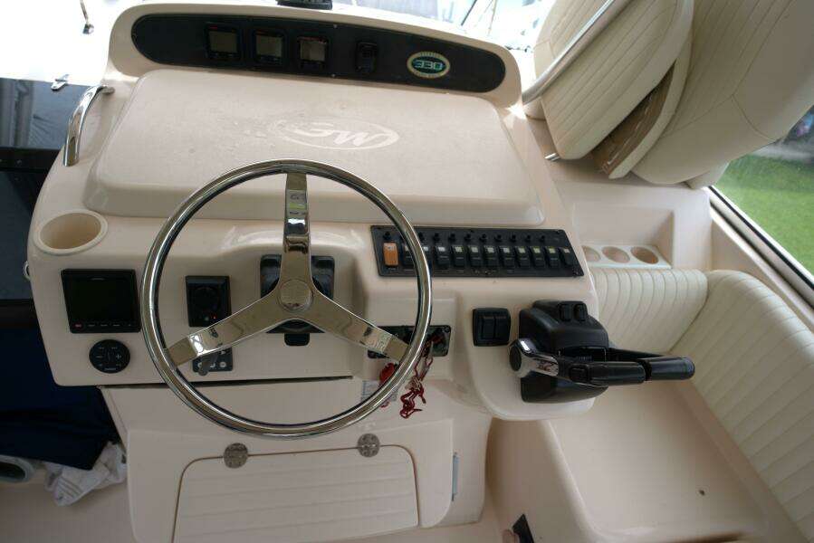 2007 Grady-White Express 330 helm with steering wheel and control panel.