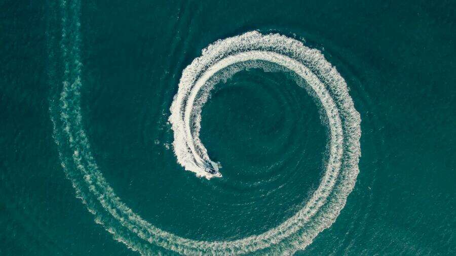 Aerial view of Oryx 379 boat making circular waves in the ocean, 2024 model.