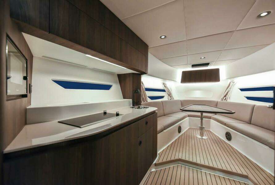 Luxurious interior of 2024 Oryx 379 yacht with modern kitchen and seating area.