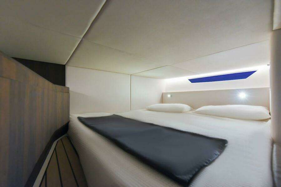 Luxurious cabin interior of 2024 Oryx 379 yacht with modern bedding and ambient lighting.