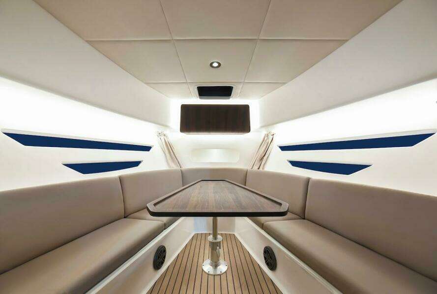 Luxurious interior of the 2024 Oryx 379 boat with elegant seating and wooden table.