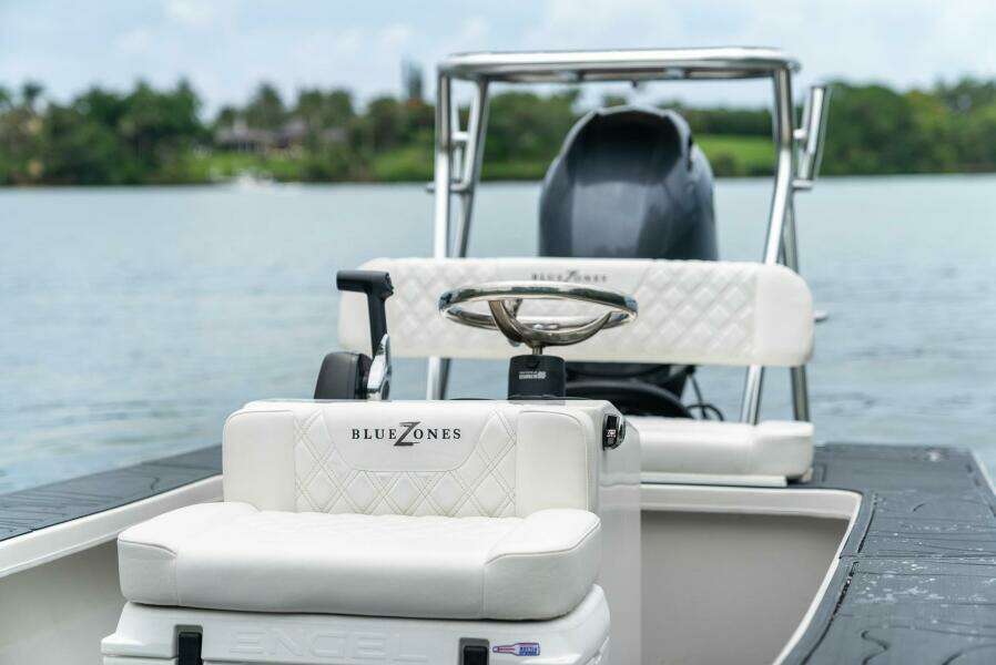 2025 BlueZones Boatworks 16' Flats boat on calm water, featuring sleek design and comfortable seating.