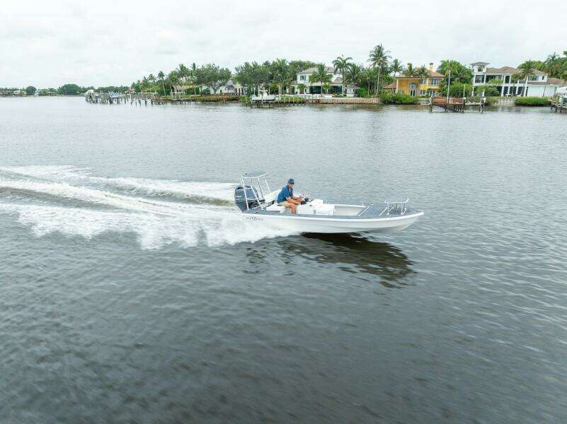 2025 BlueZones Boatworks 16' Flats cruising on a scenic waterway.