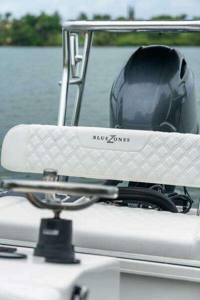 2025 BlueZones Boatworks 16' Flats boat with sleek design and powerful engine on water.