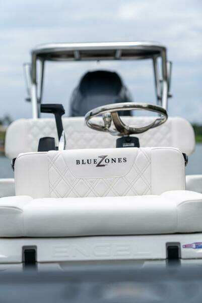 2025 BlueZones Boatworks 16' Flats boat interior with steering wheel and seating.