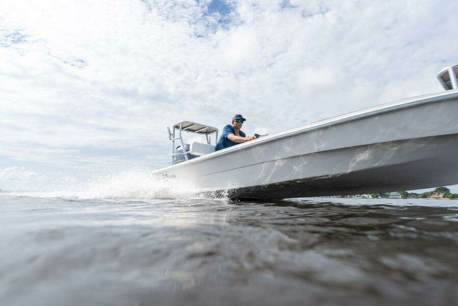 2025 BlueZones Boatworks 16' Flats skiff cruising on open water.