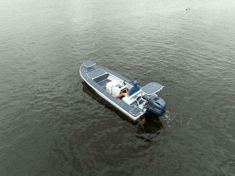 2025 BlueZones Boatworks 16' Flats boat on calm water, aerial view.