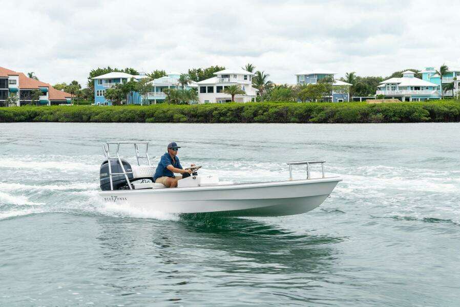 2025 BlueZones Boatworks 16' Flats cruising on a scenic waterway.