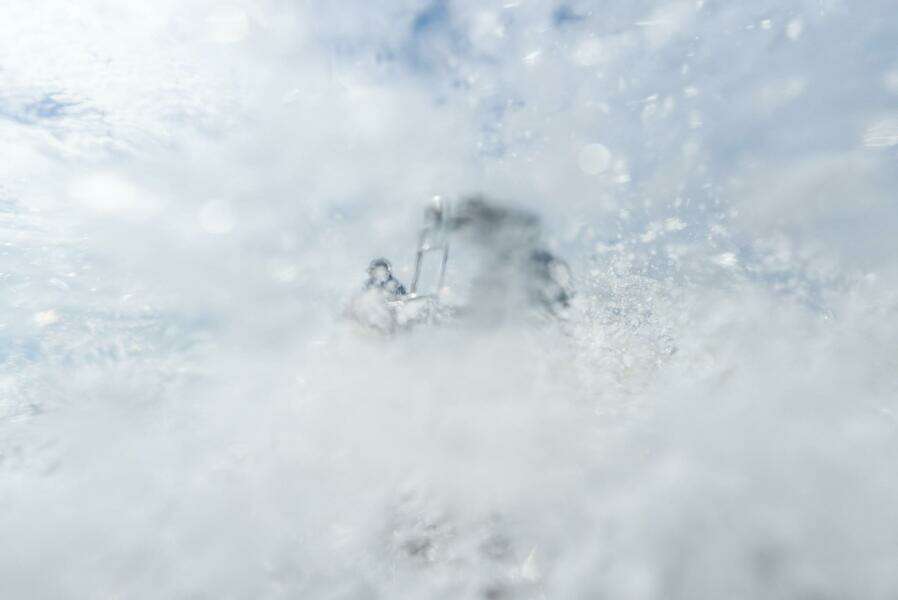 2025 BlueZones Boatworks 16' Flats navigating through splashing water.