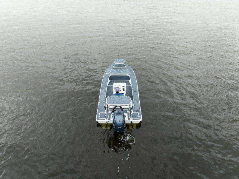 2025 BlueZones Boatworks 16' Flats boat on calm water, aerial view.