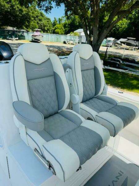 2022 Invincible 36 Open Fisherman boat seats, gray and white leather, outdoor setting.