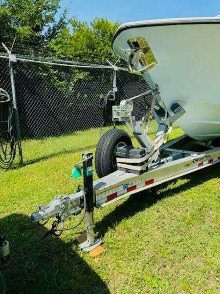 2022 Invincible 36 Open Fisherman boat on trailer, parked on grass.