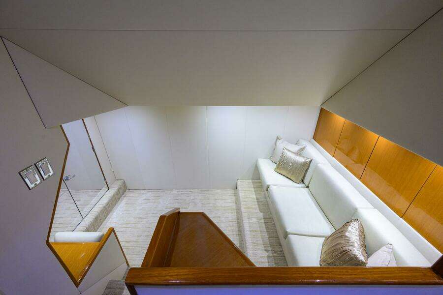 Luxurious interior of 2004 Viking 65 Enclosed Bridge yacht with white sofa and wooden accents.