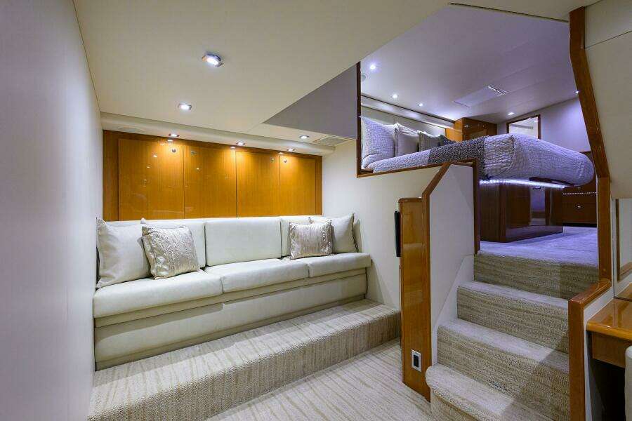 Luxurious interior of 2004 Viking 65 Enclosed Bridge yacht with elegant seating and stairs.