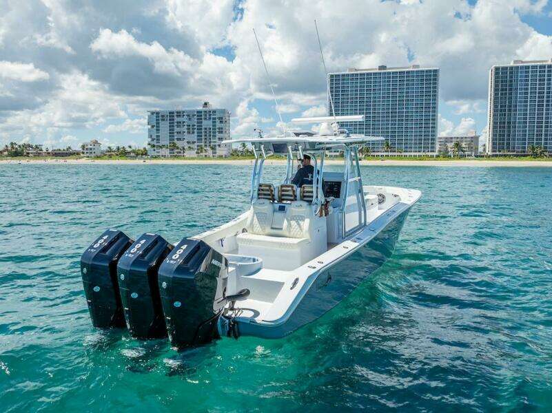 2025 Billfish 39 Center Console boat with tower on ocean near city skyline.