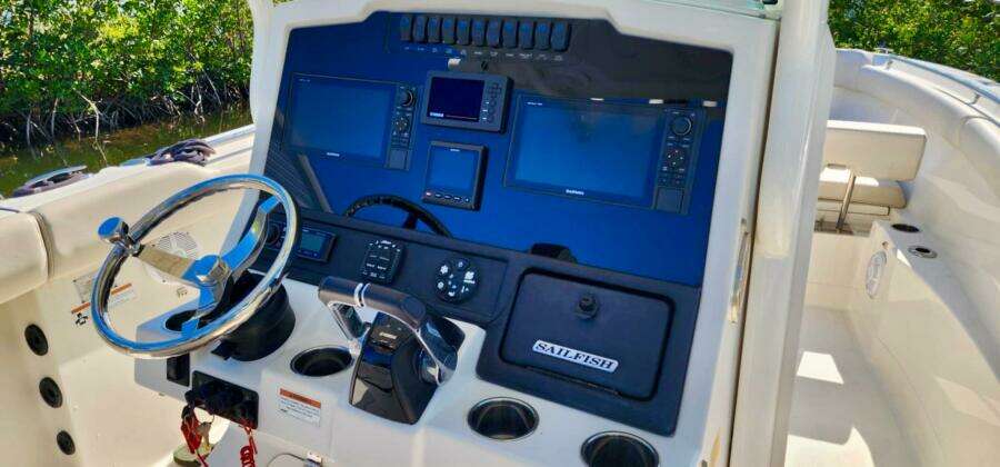 2021 Sailfish 272 CC boat dashboard with navigation controls and steering wheel.