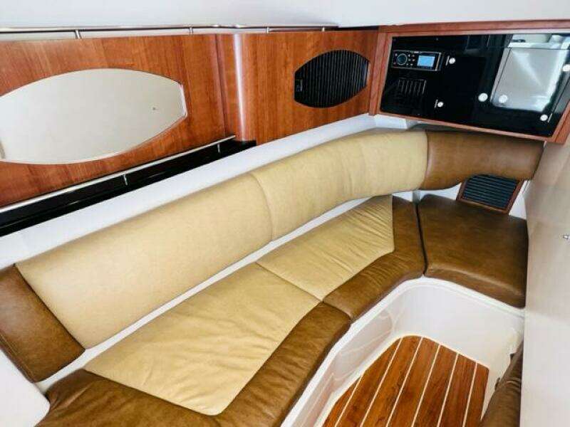 2014 Grady-White Freedom 335 cabin interior with cushioned seating and wooden flooring.