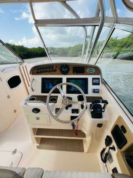 2014 Grady-White Freedom 335 boat cockpit with steering wheel and navigation controls.