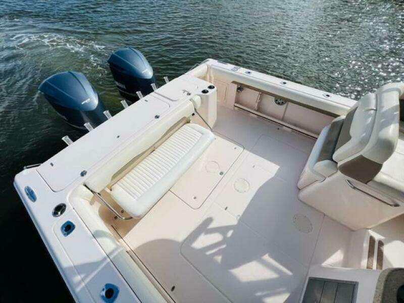 2014 Grady-White Freedom 335 boat with dual outboard motors on water.