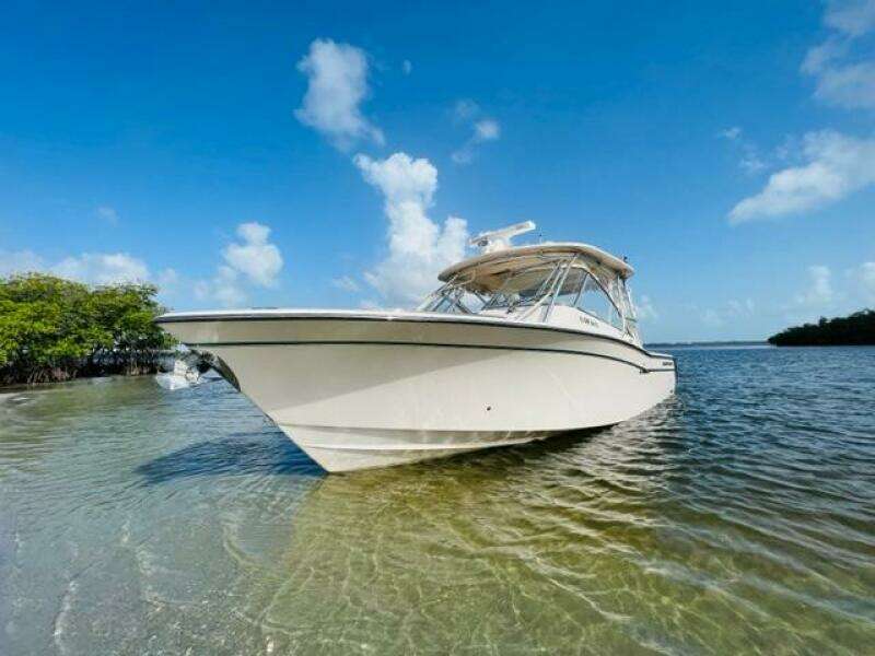 2014 Grady-White Freedom 335 boat in shallow water on a sunny day.