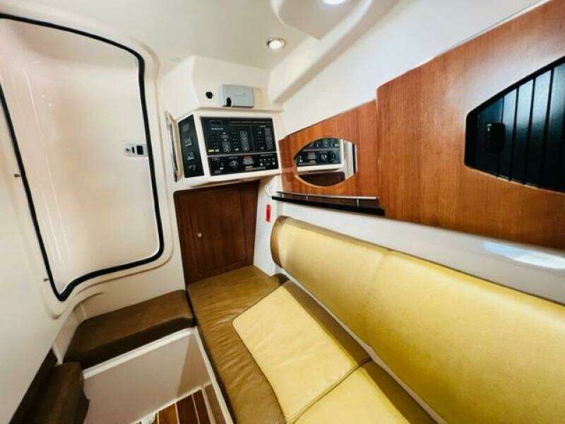 Interior cabin of a 2014 Grady-White Freedom 335 boat with control panel and seating.