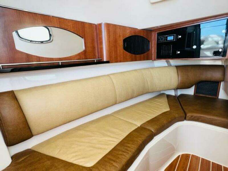 2014 Grady-White Freedom 335 cabin interior with cushioned seating and wooden accents.