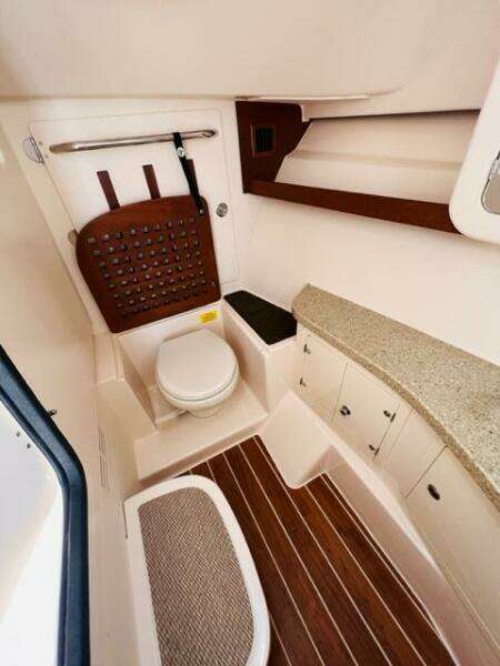 2014 Grady-White Freedom 335 boat bathroom with toilet and storage.