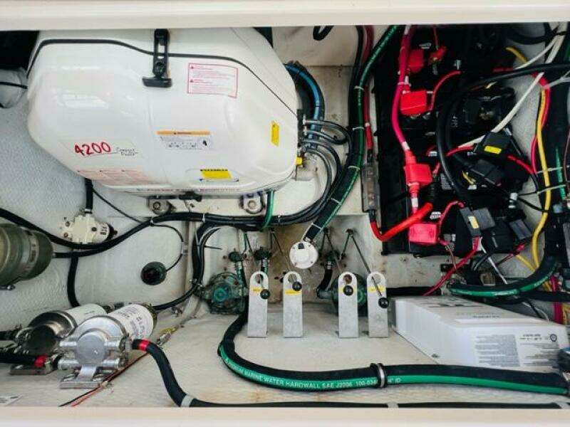 Engine compartment of a 2014 Grady-White Freedom 335 boat with various mechanical components.