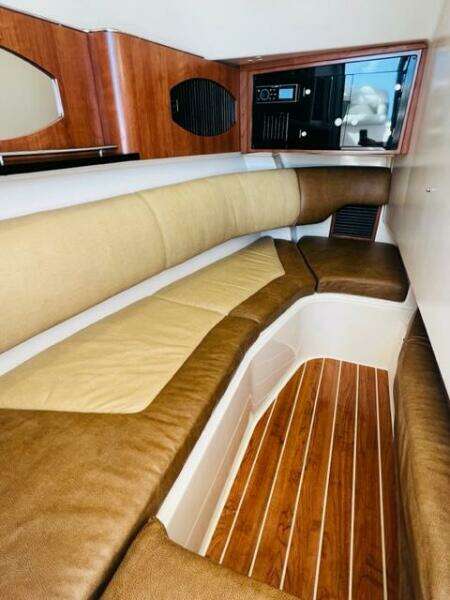2014 Grady-White Freedom 335 cabin interior with cushioned seating and wooden flooring.
