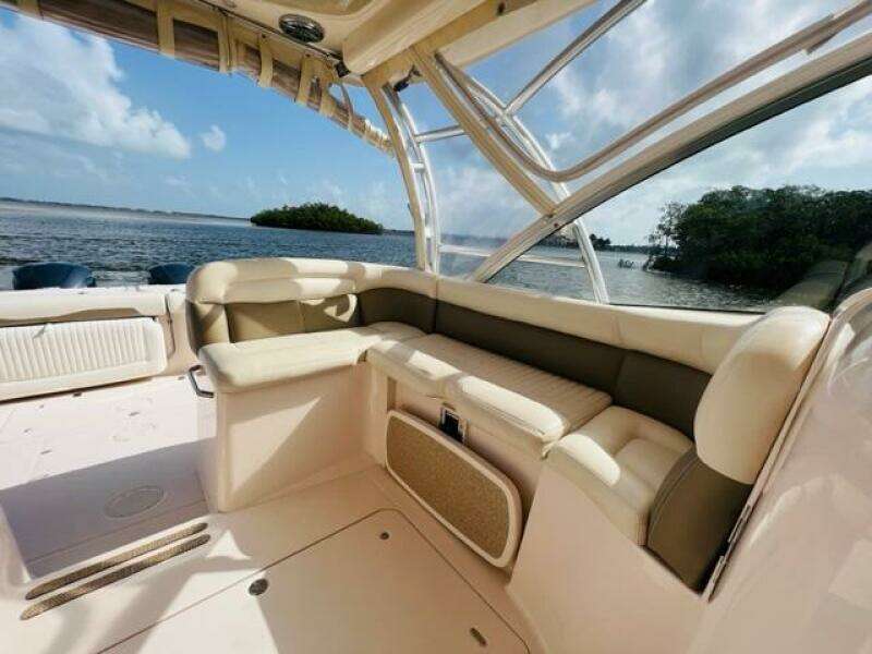 2014 Grady-White Freedom 335 boat interior with cushioned seating, ocean view in background.