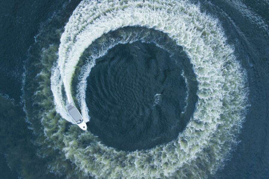 Aerial view of 2023 Real 35 Special Deck (SD) boat making a circular wake pattern.