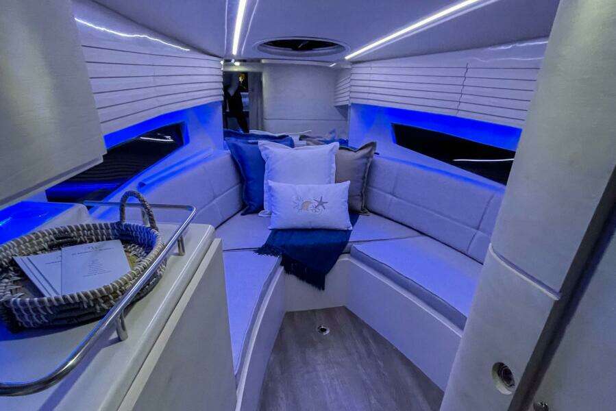 Luxurious interior of 2023 Real 35 Special Deck (SD) boat with blue LED lighting.