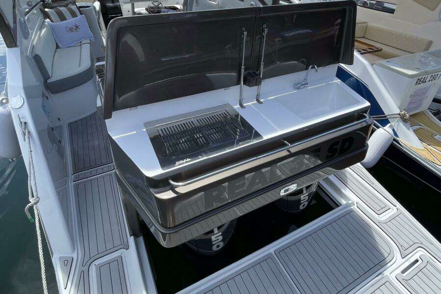 Real 35 Special Deck (SD) 2023 boat with open rear deck and built-in grill.