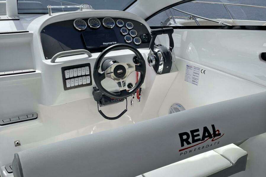 Real 35 Special Deck (SD) 2023 boat cockpit with steering wheel and control panel.