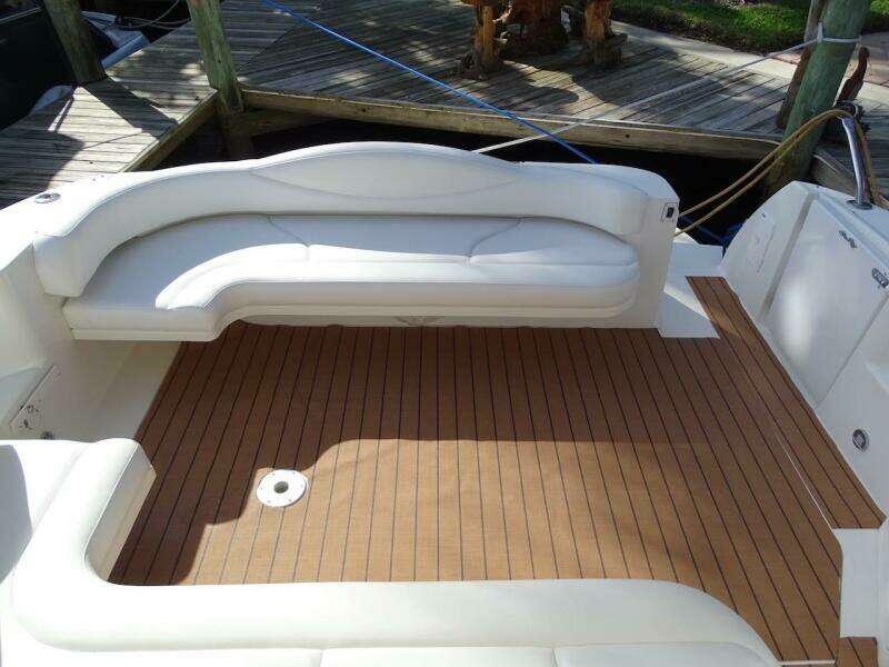 2001 Sea Ray 410 Sundancer boat deck with white seating and wooden flooring.