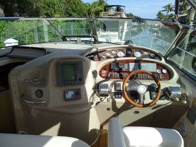 Helm of 2001 Sea Ray 410 Sundancer yacht with navigation equipment and steering wheel.