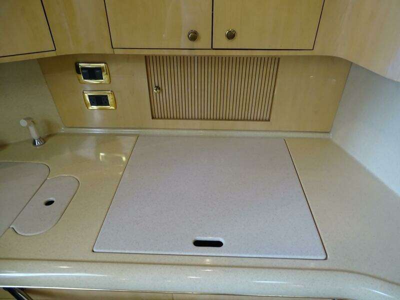 2001 Sea Ray 410 Sundancer kitchen countertop with sink and stove cover.