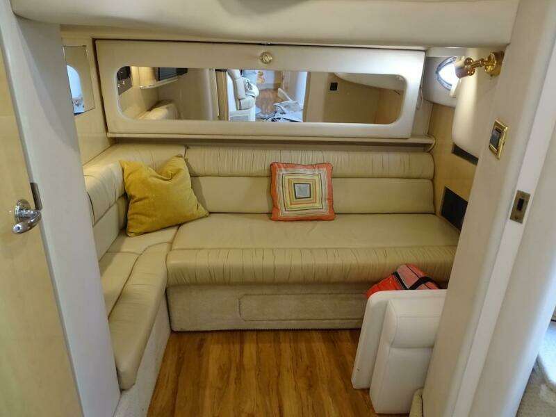 Interior of 2001 Sea Ray 410 Sundancer with beige seating and decorative pillows.