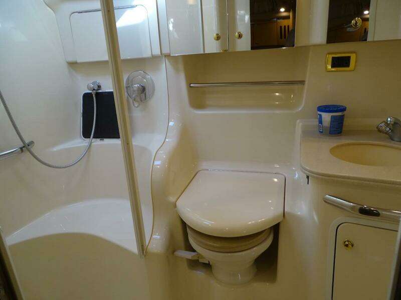 2001 Sea Ray 410 Sundancer bathroom with shower, toilet, and sink.