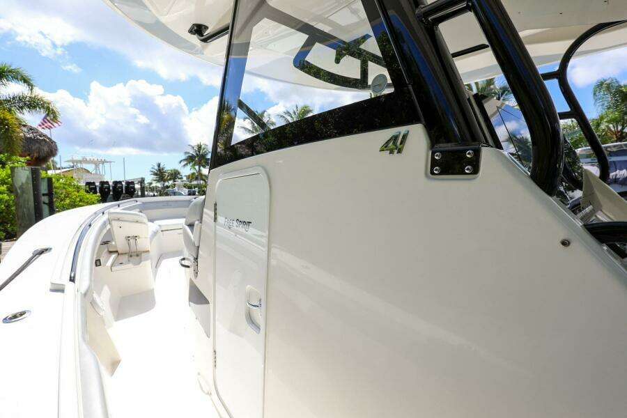 2020 Regulator 41 boat, side view with cockpit and seating area, docked under sunny skies.