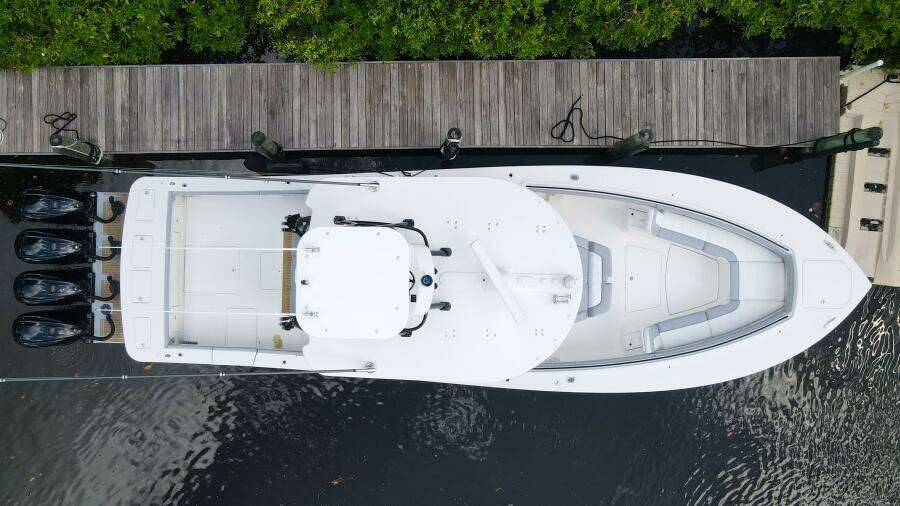 Aerial view of a 2020 Regulator 41 boat docked by a wooden pier.