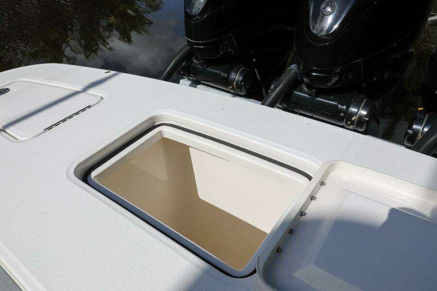 2020 Regulator 41 boat with open storage compartment and dual outboard engines.