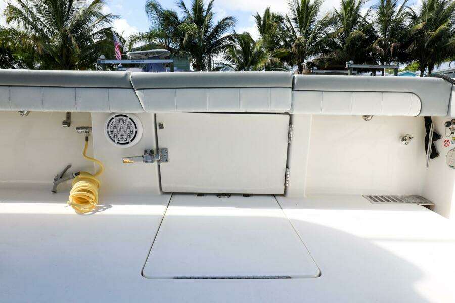 2020 Regulator 41 boat deck with storage compartments and coiled hose.