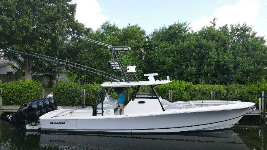 2020 Regulator 41 boat docked near lush greenery.