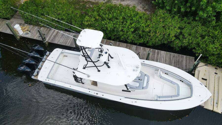 Aerial view of a 2020 Regulator 41 boat docked by a wooden pier.