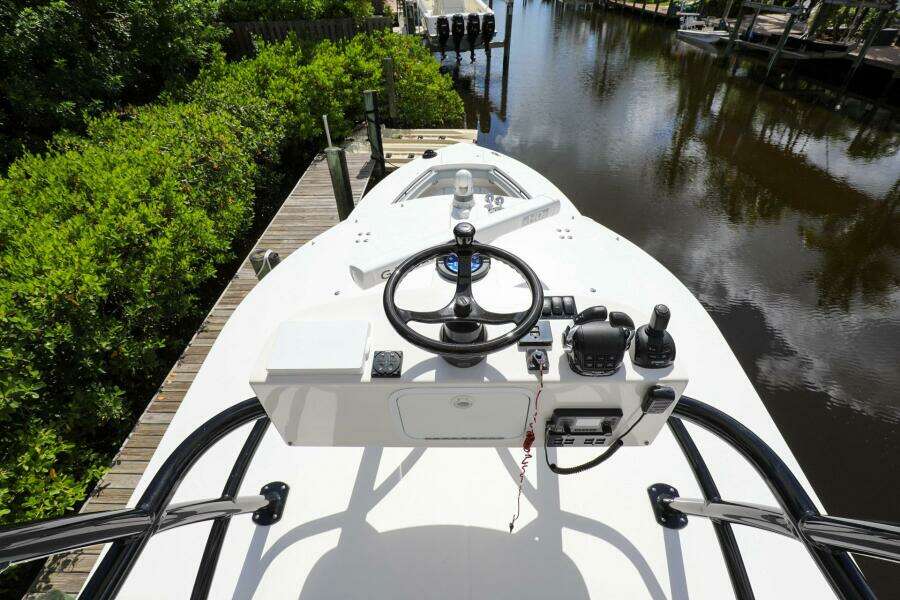 2020 Regulator 41 boat helm station docked by a canal.
