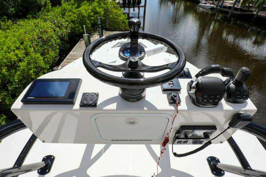 2020 Regulator 41 boat helm with steering wheel, controls, and navigation equipment.