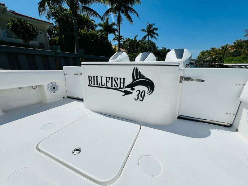 2015 Billfish 39 Custom CC boat deck with logo, palm trees in background.