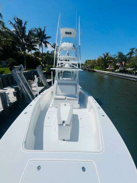 2015 Billfish 39 Custom CC boat docked in a sunny canal.