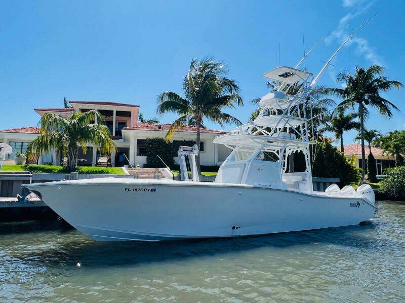2015 Billfish 39 Custom CC boat docked near a waterfront home.
